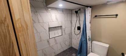 Custom marble walk-in shower by Bunz and Sonz Construction