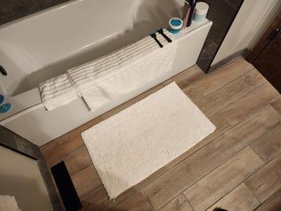 Wood-look tile floor detail with dark border transition