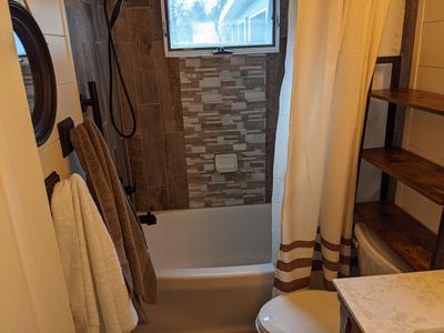 Farmhouse bathroom with rustic wood tile shower
