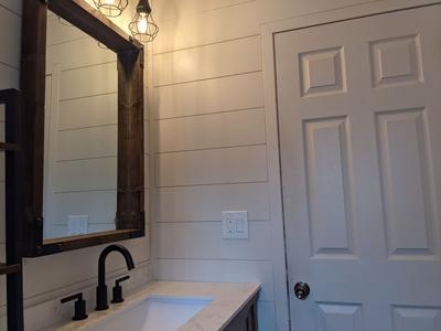 Farmhouse vanity with shiplap and industrial lights