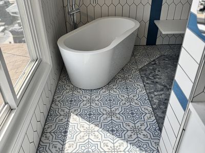 Freestanding tub detail with decorative patterned floor tile
