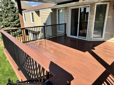 Deck surface with sliding doors and black railings