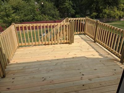 Raised wood deck from above with picket railings
