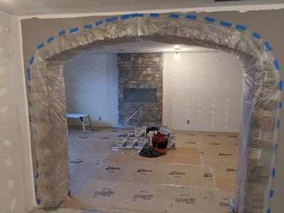 Stone archway with drywall mudding in progress