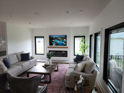Living room with wood fireplace surround and custom built-ins