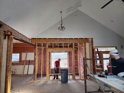 The crew framing on site — who we are