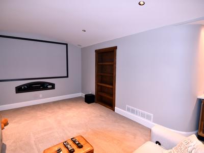 Basement home theater with bookshelf door