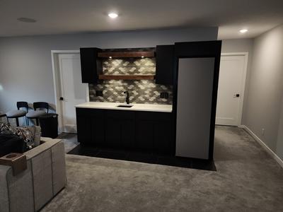 Basement wet bar with geometric backsplash