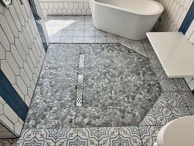 Bathroom floor with pebble stone and cement tile