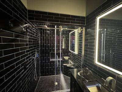 Dramatic all-black bathroom with LED mirror