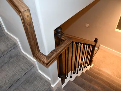 Custom staircase handrail with iron balusters
