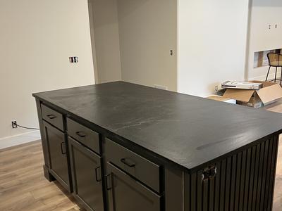 Basement bar island with black shaker cabinets