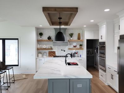 Finished kitchen with blue island and custom cabinetry