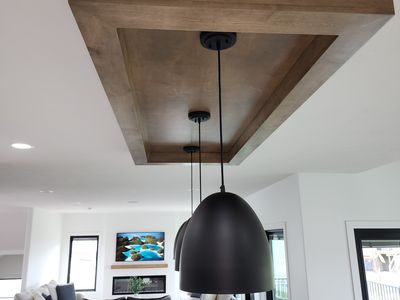 Floating wood medallion with pendant light — ceiling detail