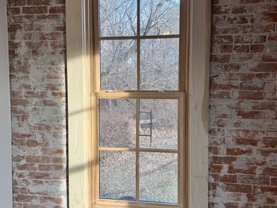 Craftsman window trim in historic exposed brick building