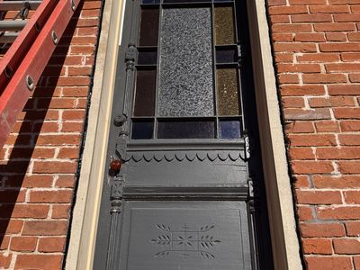 Ornate historic door restoration — original detail preserved