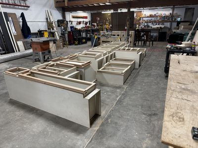 Cabinet boxes laid out in the woodshop — ready to install