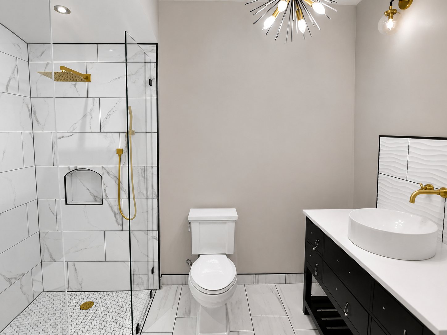 Custom bathroom remodel with marble tile shower and brushed gold fixtures in Omaha